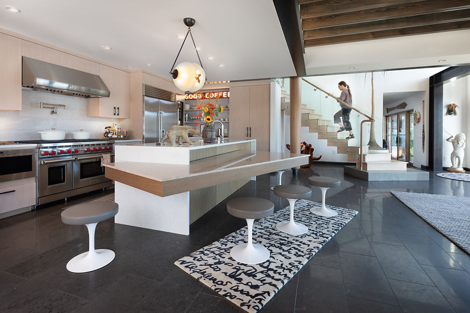 Modern Bainbridge Island kitchen remodel by Fairbank Special Services, featuring custom cabinetry, luxury appliances, and seamless integration with open-concept living spaces.