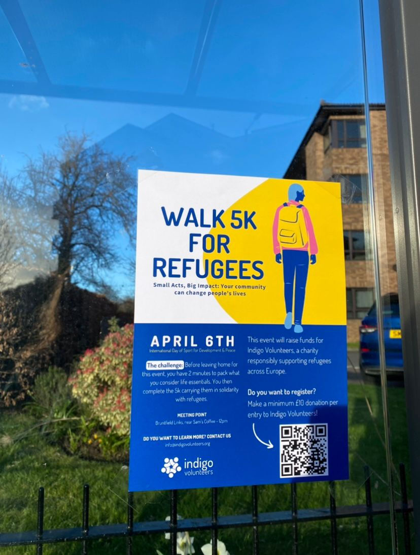 The Indigo Walk 5k for Refugees event posters stuck on a bus stop window