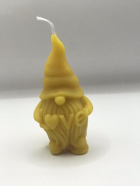 Adorable beeswax gnome candle holding love heart