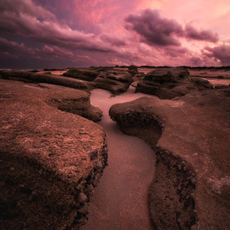 Pink sunset over the coquina rocks in Marineland Florida.