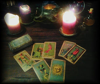Deck of the Bastard on desk with candles