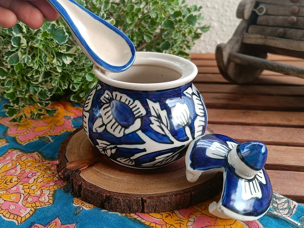 A beautiful dark blue and white ceramic jar with lid and spoon