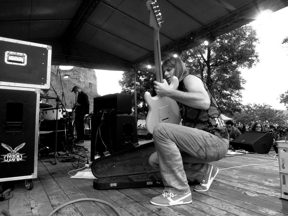 Close-up view of vintage electric guitar leaning against amplifier