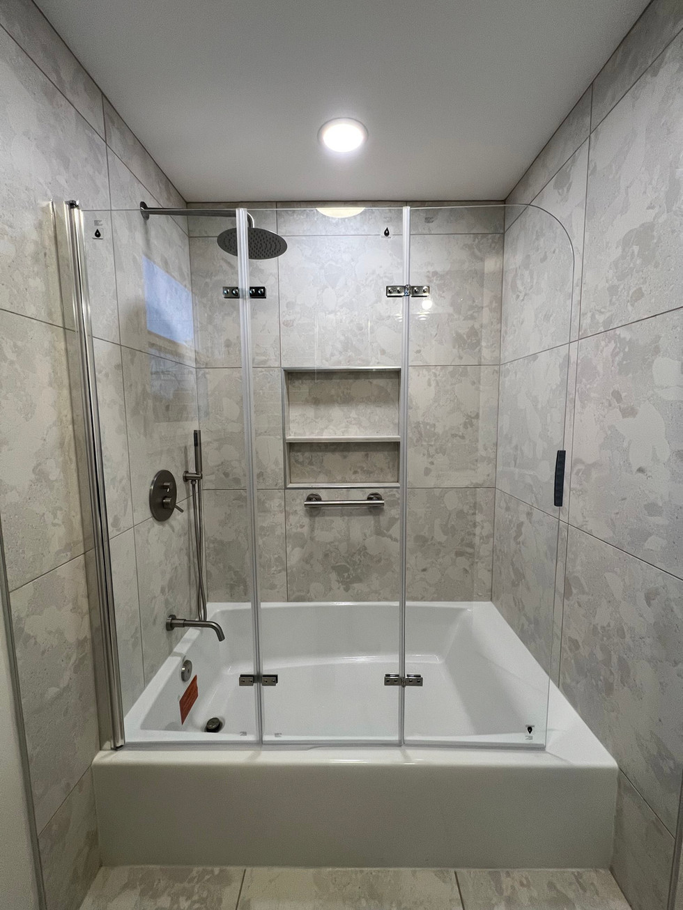 a bathroom with a bathtub and a shower stall