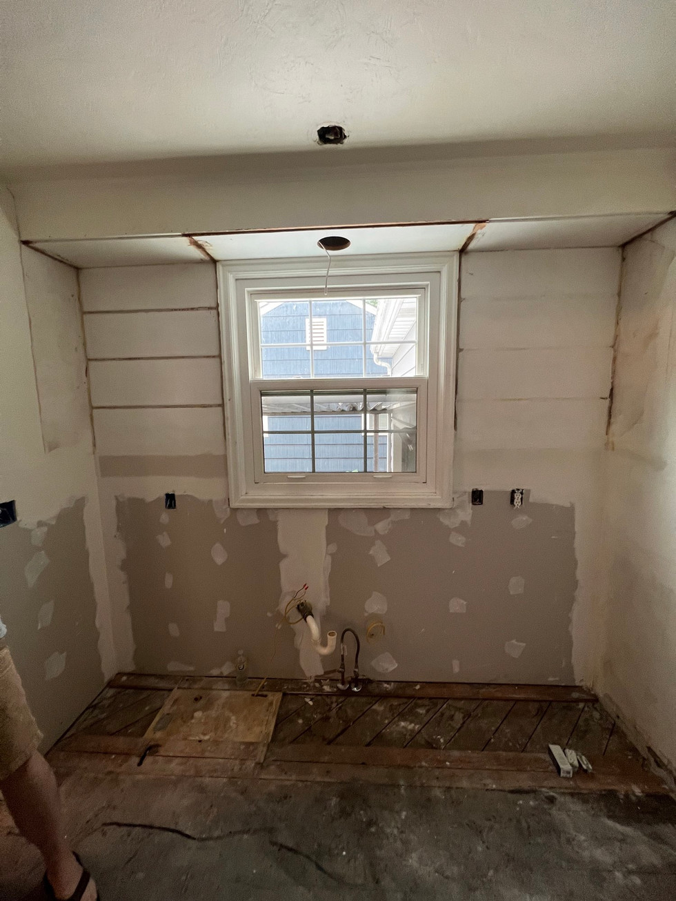 a kitchen under construction with a window and a sink