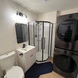 a bathroom with an lg washer and dryer stacked on top of each other