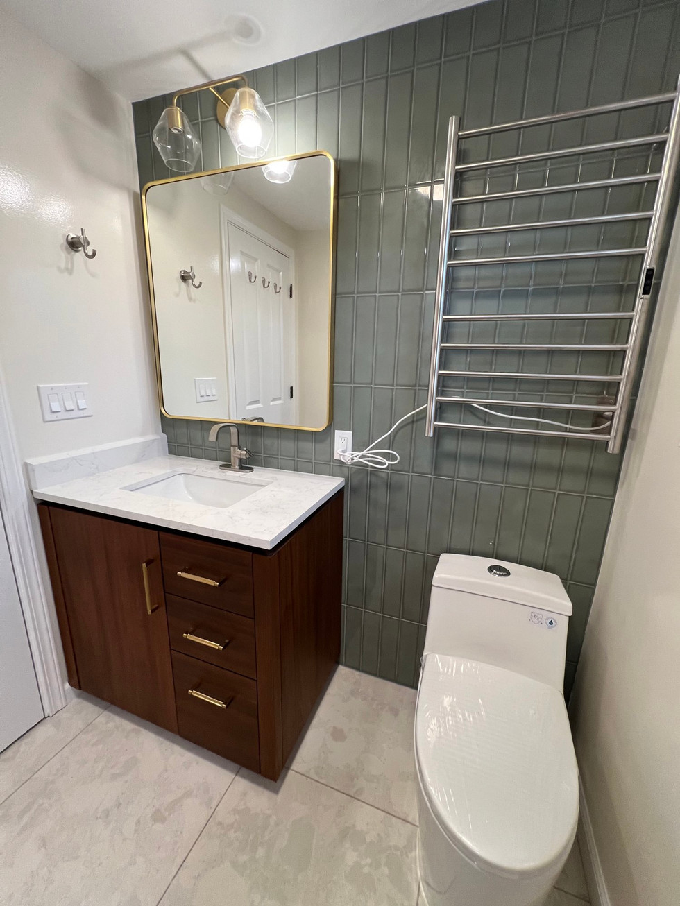 a bathroom with a toilet a sink and a mirror