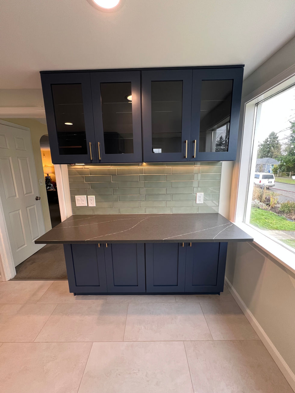 a kitchen with blue cabinets and a gray counter top