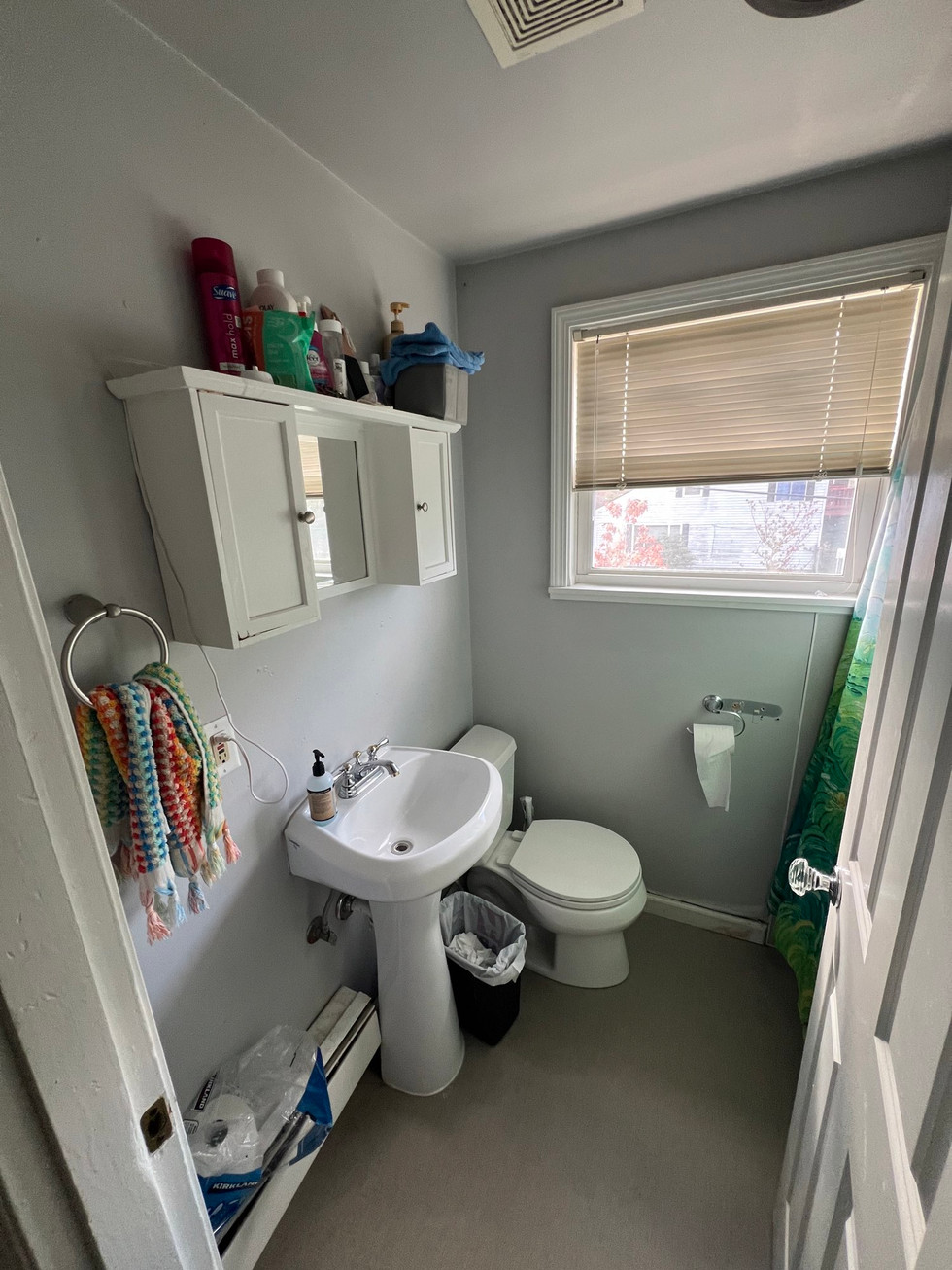 a bathroom with a toilet a sink and a window