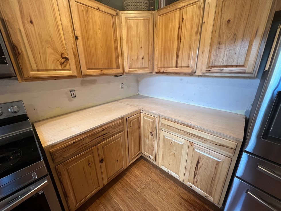 a kitchen with wooden cabinets and a stainless steel appliance