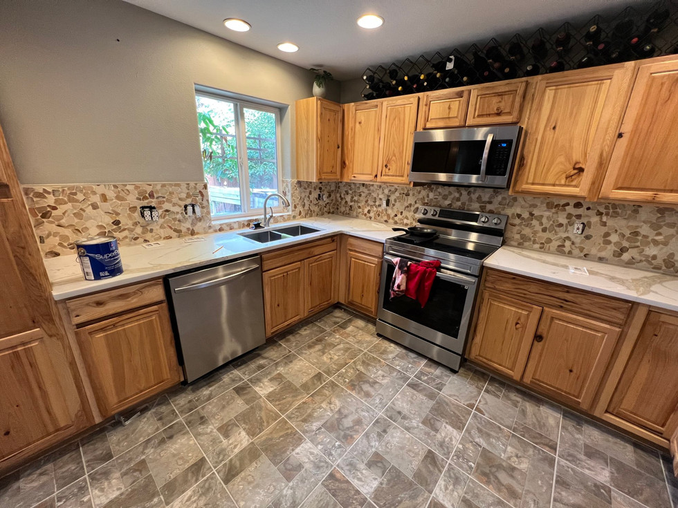 a kitchen with wooden cabinets and stainless steel appliances