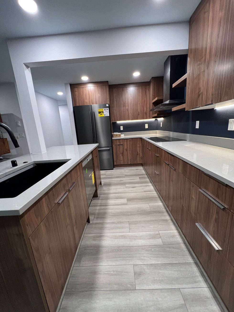 a kitchen with wooden cabinets and white counter tops