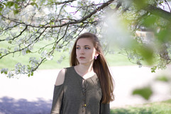 Portrait of woman under white flowering tree