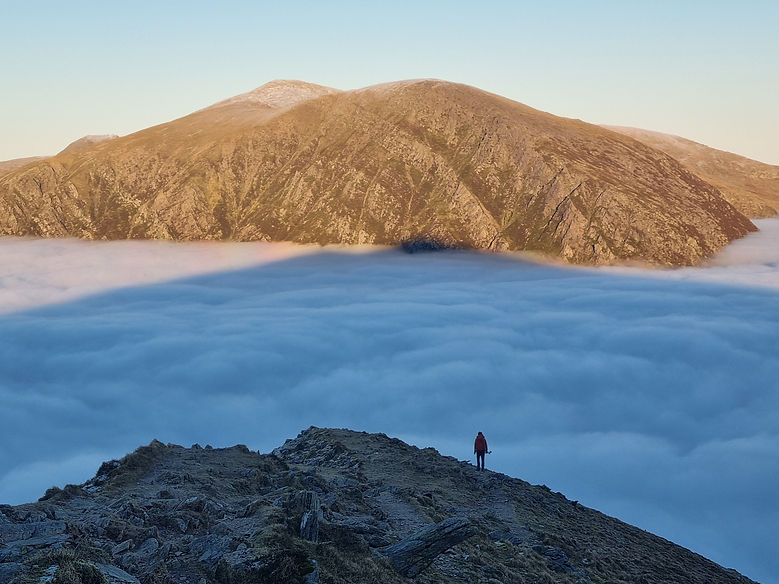 Walking of Y Garn towards Pen Yr Ole Wen with a temnperature inversion at sunset in Snowdonia