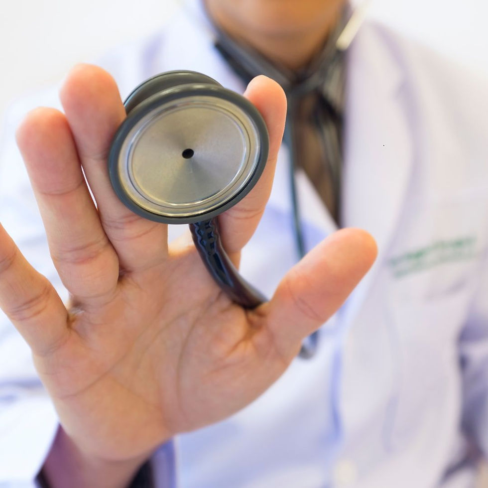 Doctor in white coat holding a stethoscope facing the camera, focus on the stethoscope, blurred background, professional setting.
