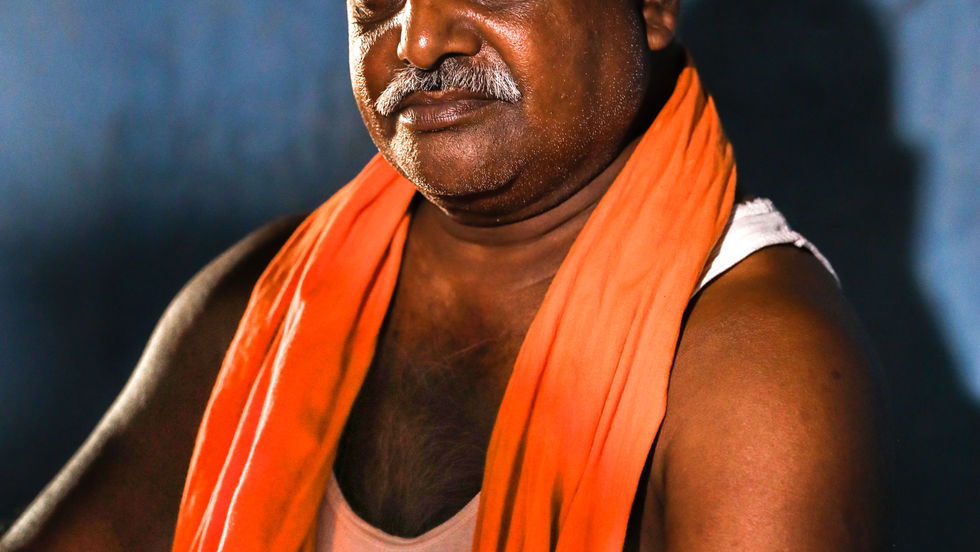 Priest sits in Lotus Asana.jpg