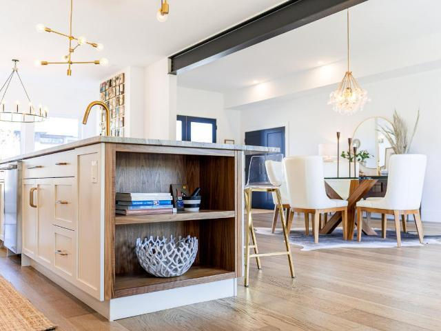 a kitchen with a large island and a dining room in the background .