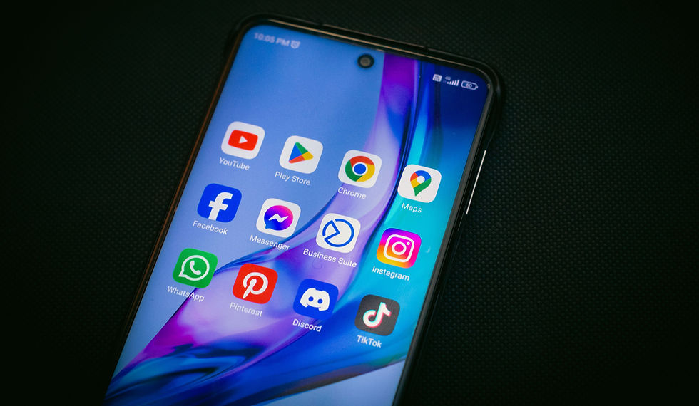 Close-up of a smartphone screen displaying popular social media and tech apps like Instagram, Facebook, and TikTok on a dark background.