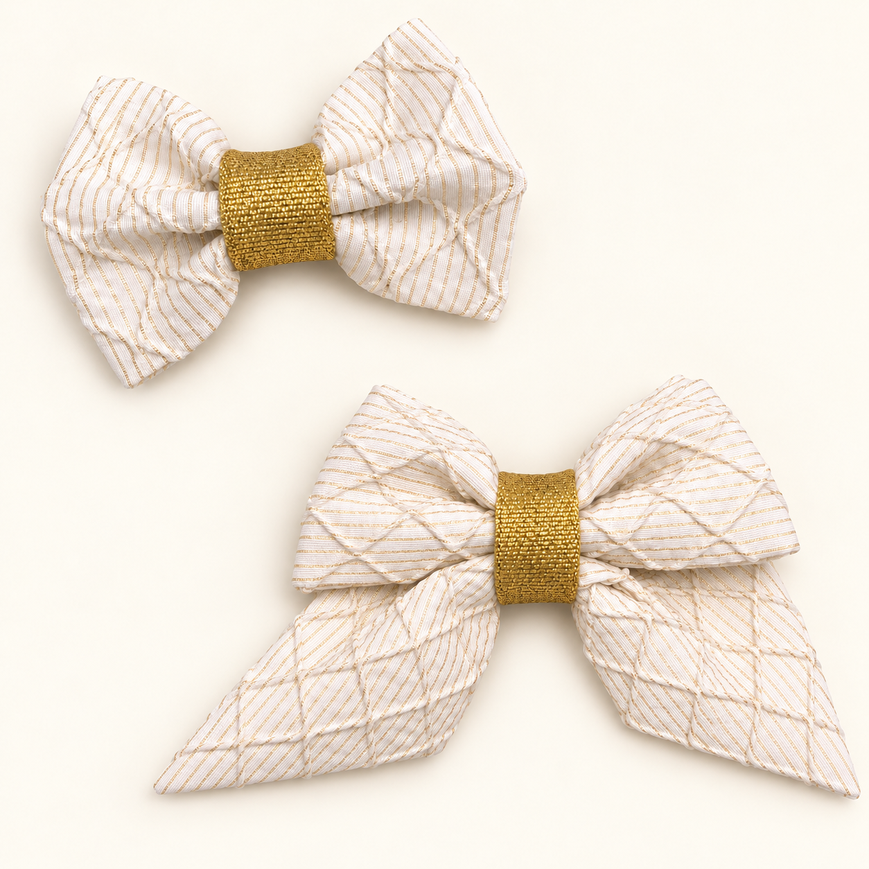 Ivory classic and sailor bows with raised diamond texture and gold center wraps.