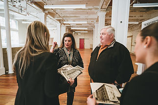 Purse family visiting the Purse Building with Tanya Ragan of Wildcat Management and visiting old photographs of purse furniture warehouse from 1928