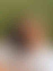 Playful couple sharing pizza at Loose Park in Kansas City