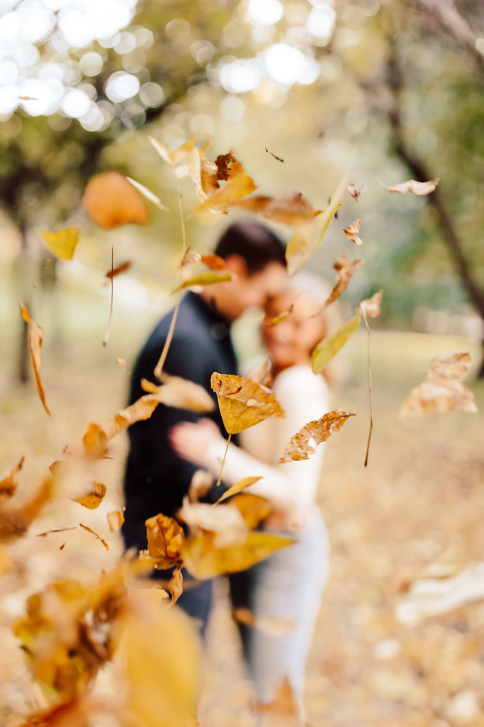 Casually Engaged Couple with Fall Leaves for Engagement Photos