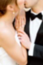 Intimate Close Up Photo of Bride and Groom Kissing With Wedding Rings