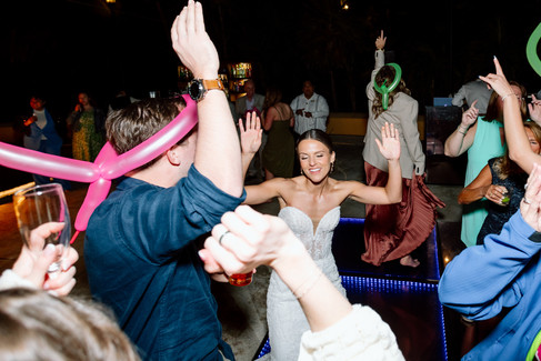 Bride lifted on dance floor during high-energy reception at Riviera Maya wedding celebration