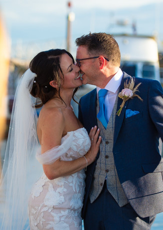 Newlyweds kiss on the marina at The Royal Southern Yacht Club, Hamble.