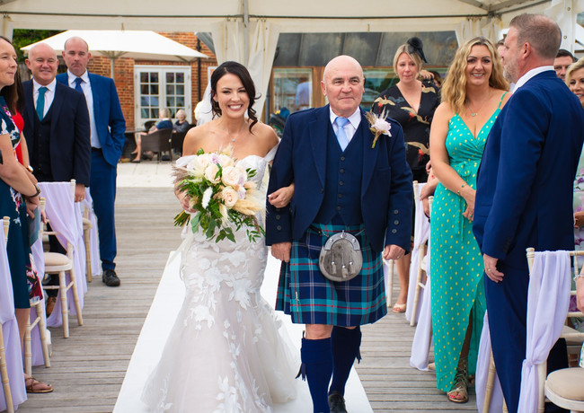 Father and bride walking the aisle at her wedding on the marina at The Royal Southern Yacht Club, Hamble.