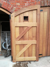 Arched hardwood garage doors
