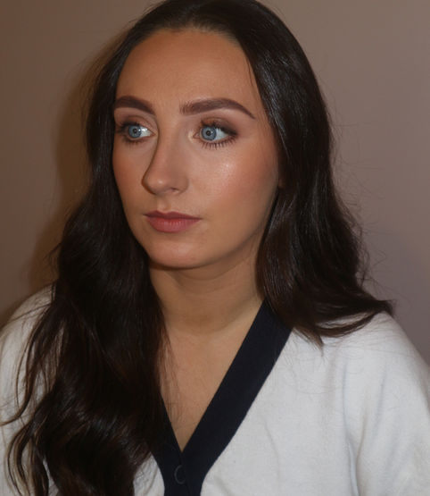 A dark haired lady showing off her natural makeup 