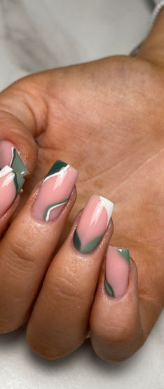A hand with green, white and pink nail art 