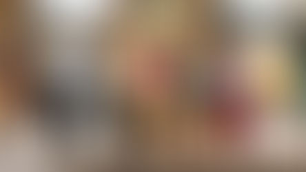 Five people stand in a lively street beneath banners. One person excitedly raises arms. Bright outfits contrast the stone background. Text: Marine Victory Day.