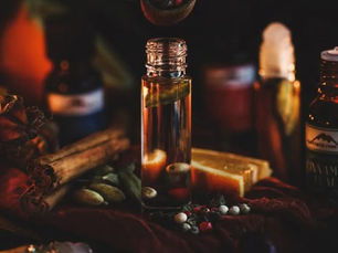 a glass bottle next to cinnamon