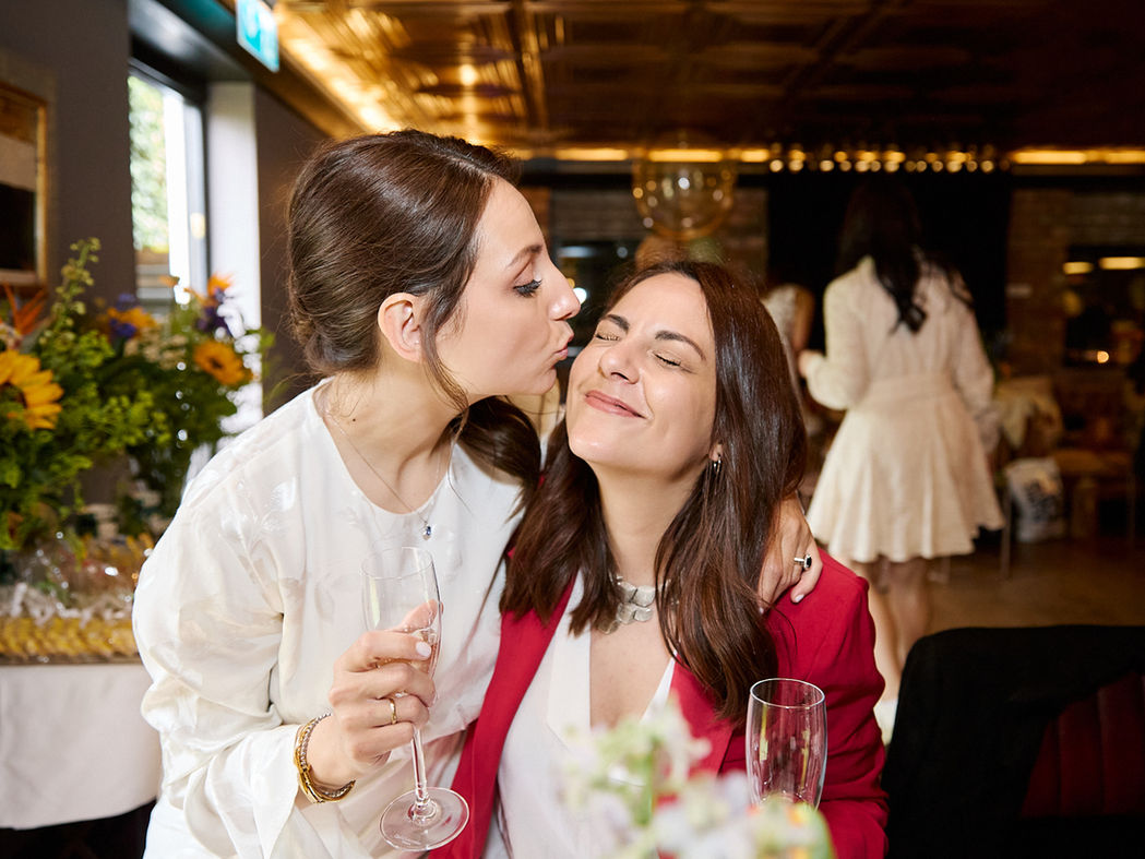 A lady kissing her friend at an event in London.