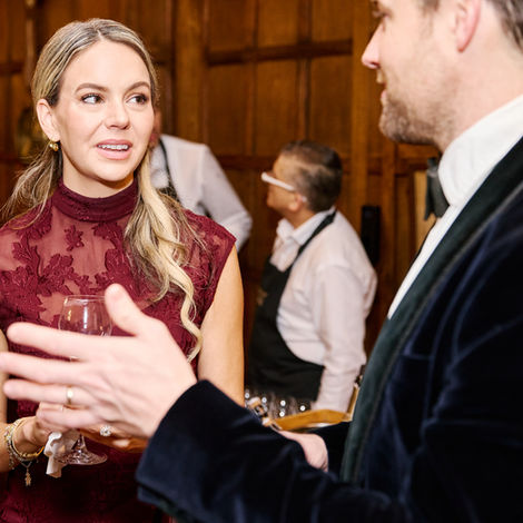 Woman in red dress conversing at birthday event
