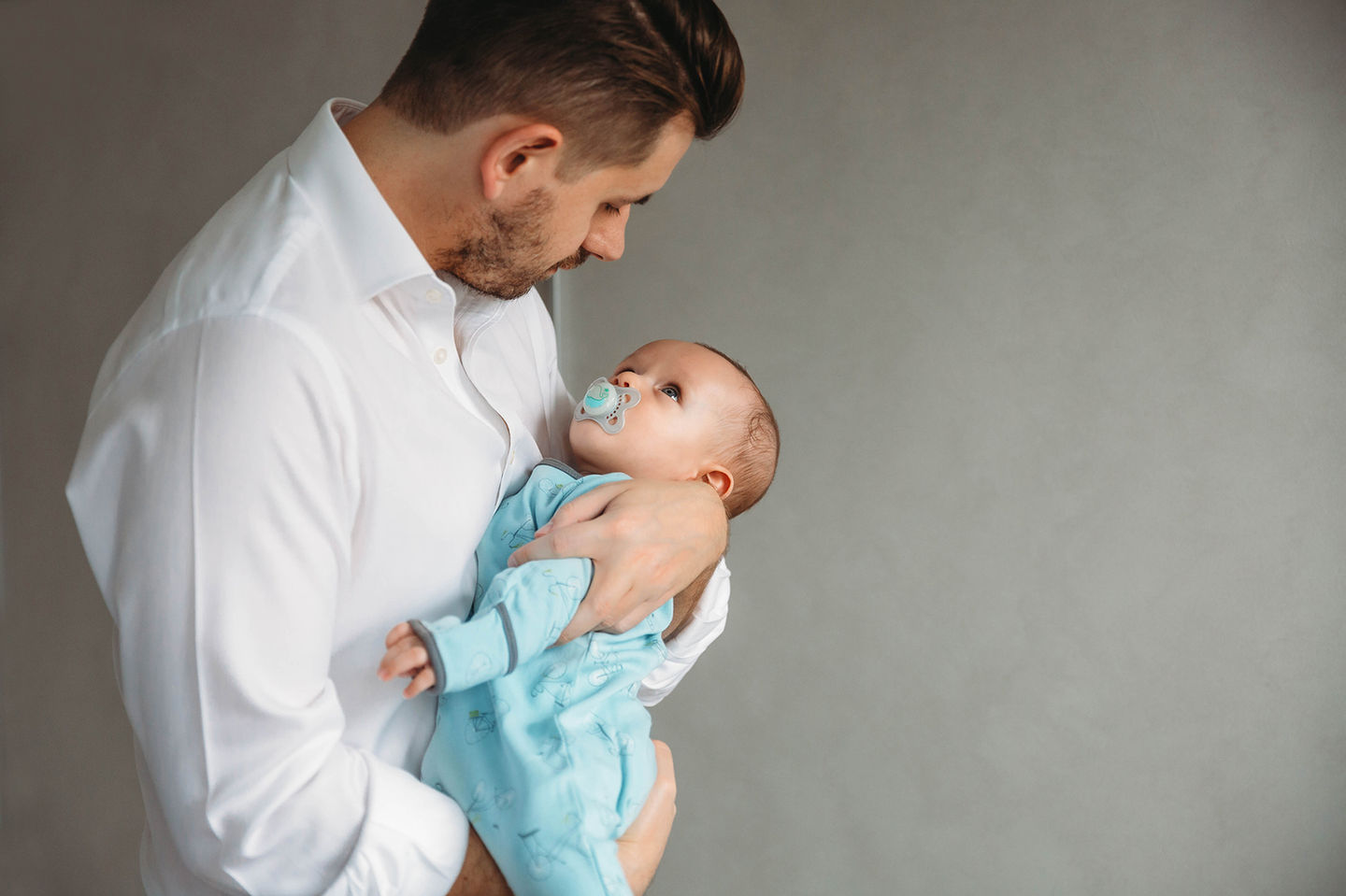 Dad holding his baby.