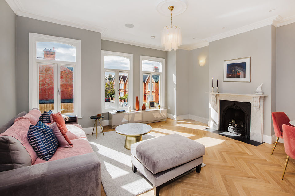 Interiors photography London sunlit lounge with fireplace