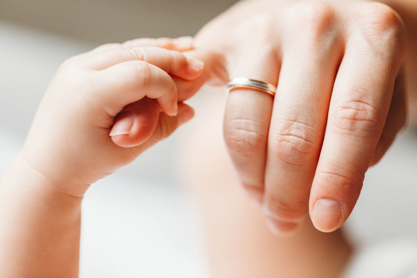 family photography baby touches mums hand