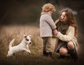 Little boy with his sister and a dog.