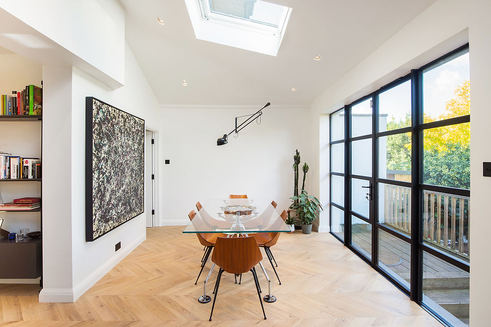 A modern interior of a lounge with a dining table by the window.