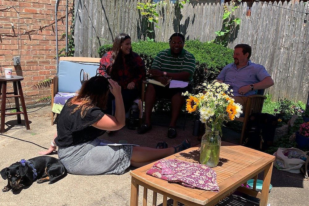 Open Communities staff retreat 2021. Four people talking in a circle.
