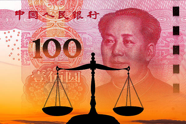 Balanced scales on on chinese yuan note background