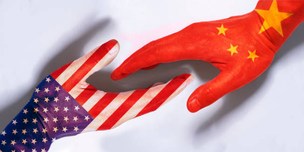 Handshake of Chinese and American political leaders. Isolated icon of meeting and talks between China and USA. Two hands of Western and East Asian politicians. GettyImages