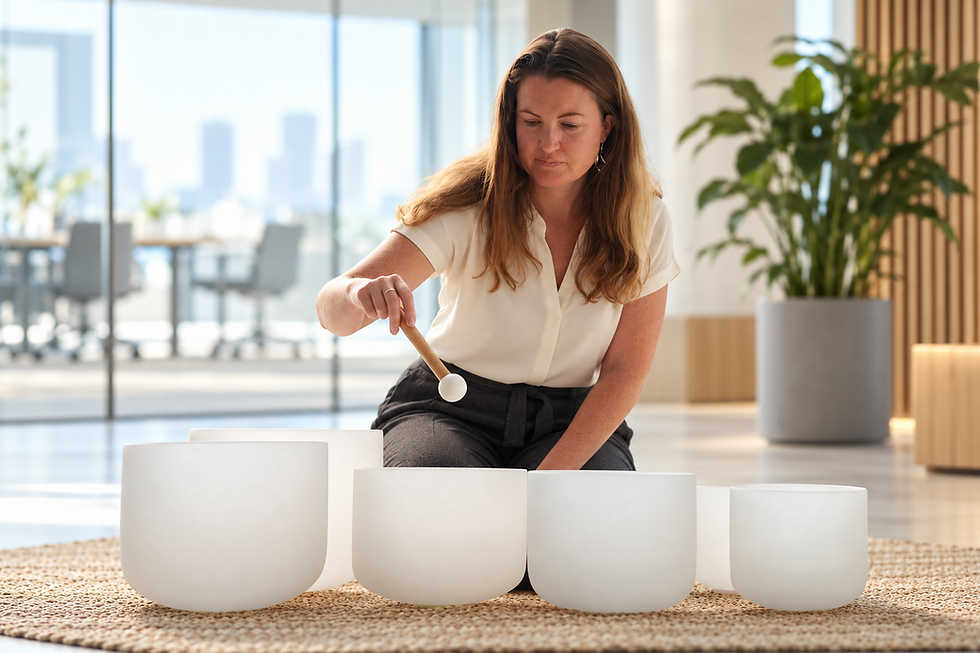 Woman performing a sound bath with crystal bowls in a corporate environment