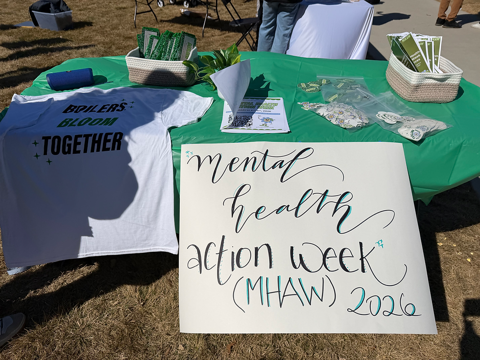 A hand-drawn MHAW 2026 poster, stickers, and t-shirts at an outdoor booth, via Apuroopa Kavikondala