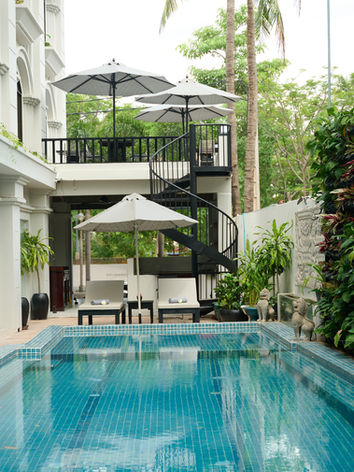 Swimming pool with lounge chairs and terrace at Home.