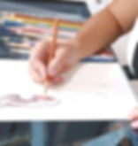 Noriko Drawing a dinosaur using colored pencil