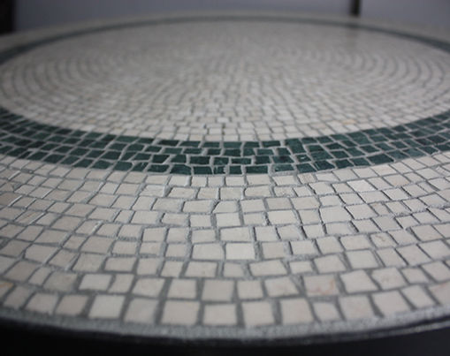 Close up of mosaic table top on white and green marble